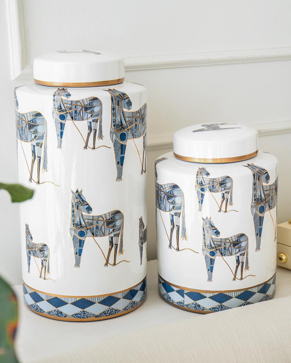 Eloisa Bundle canisters in white and blue, shown in a lifestyle left view as image 2
