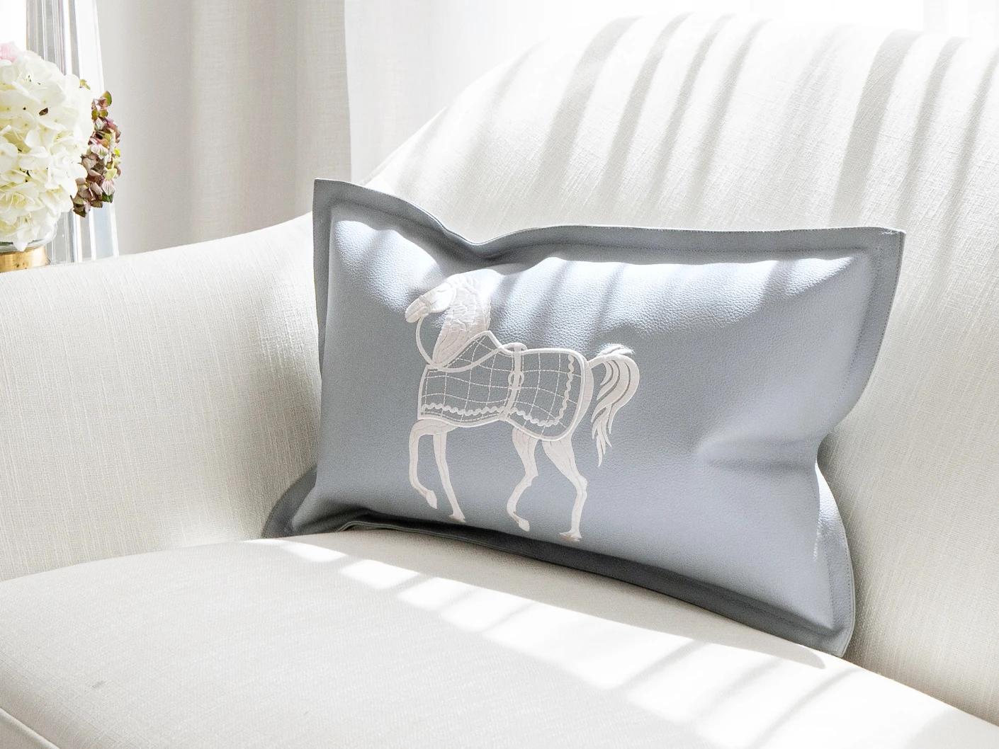 Filip Matisse cushion in blue and white, shown in a lifestyle front view as image 2