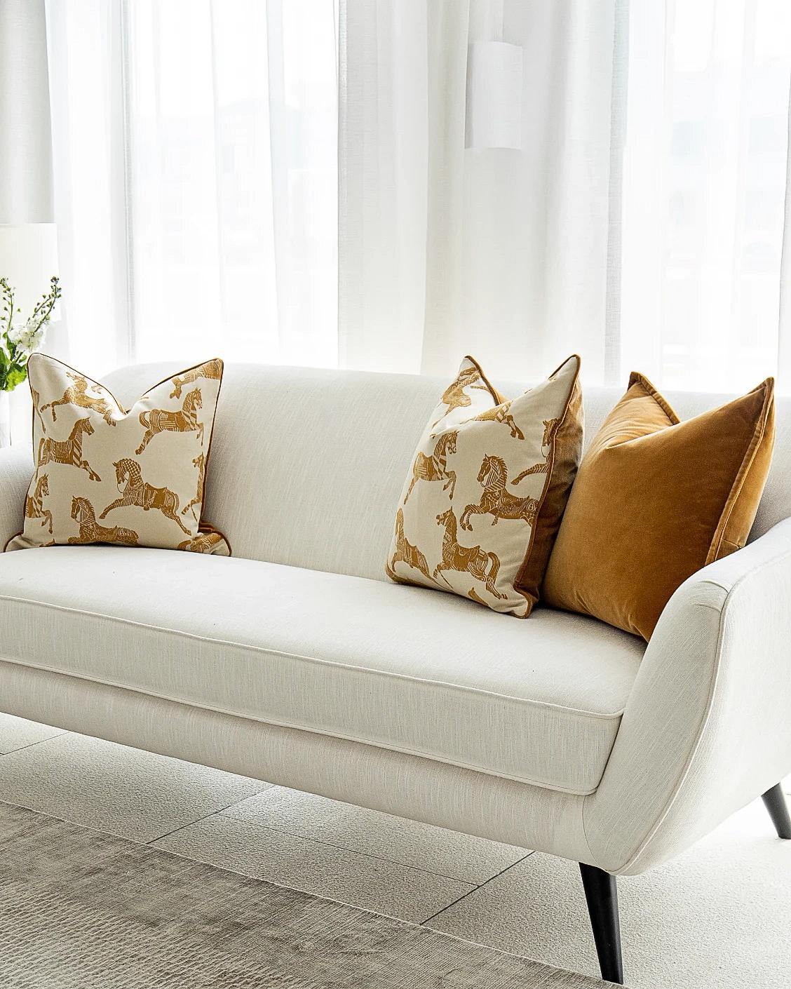 Arie Bundle cushion in orange and beige, shown in a lifestyle right view as image 2