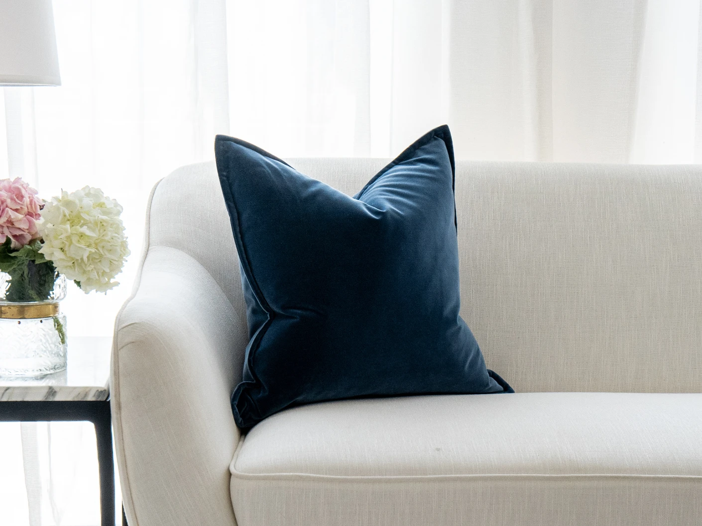 Alessandra Canova single cushions in royal blue and blue, shown in a lifestyle front view