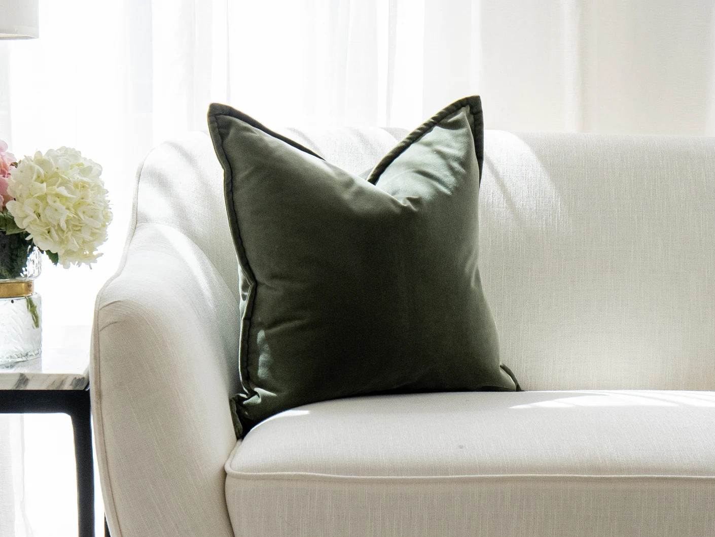 Alessandra Forest single cushions in green and forest green, shown in a lifestyle front view