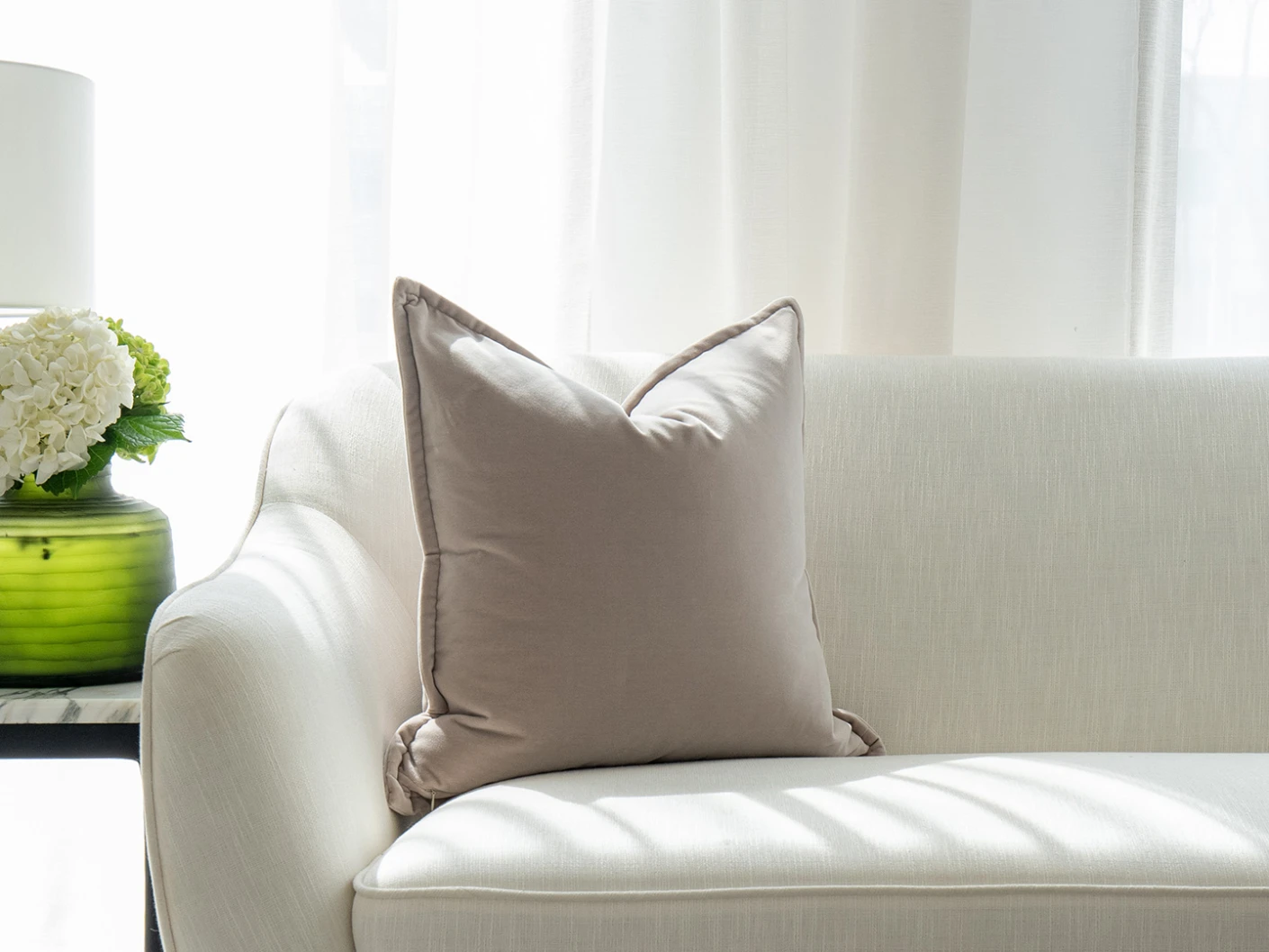 Alessandra Klimt single cushions in beige, shown in a lifestyle front view