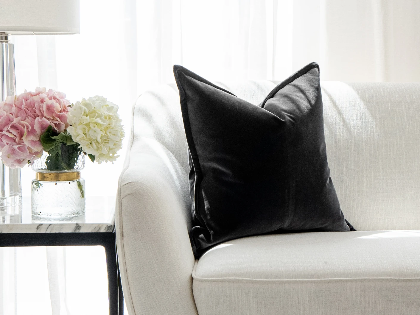 Alessandra Steele single cushions in charcoal and grey, shown in a lifestyle front view