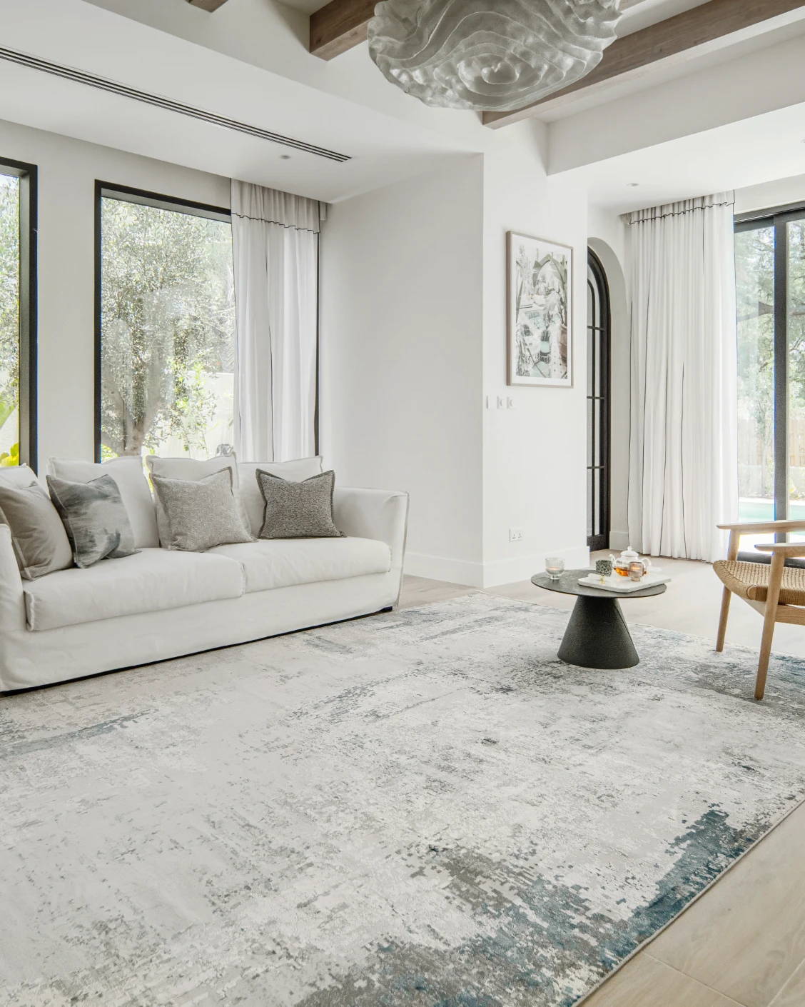 Athena Sky carpet in sky, blue and grey, shown in a lifestyle left view as image 8