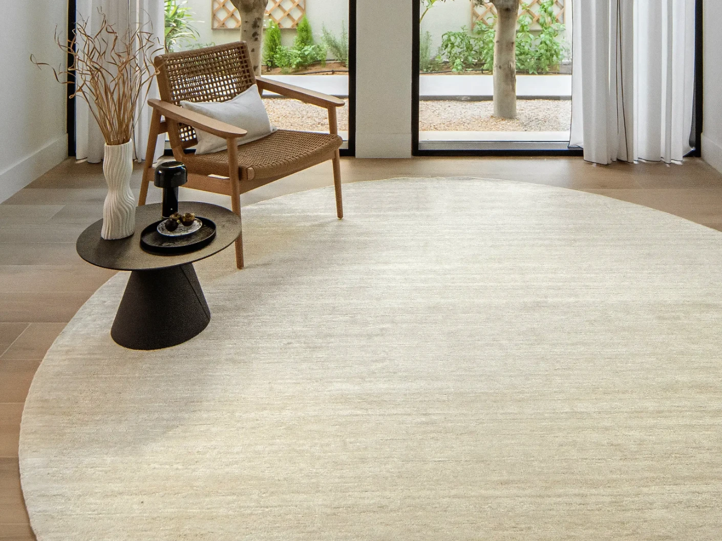 Beatrice Sandy 02 Round carpet in beige, shown in a lifestyle front view