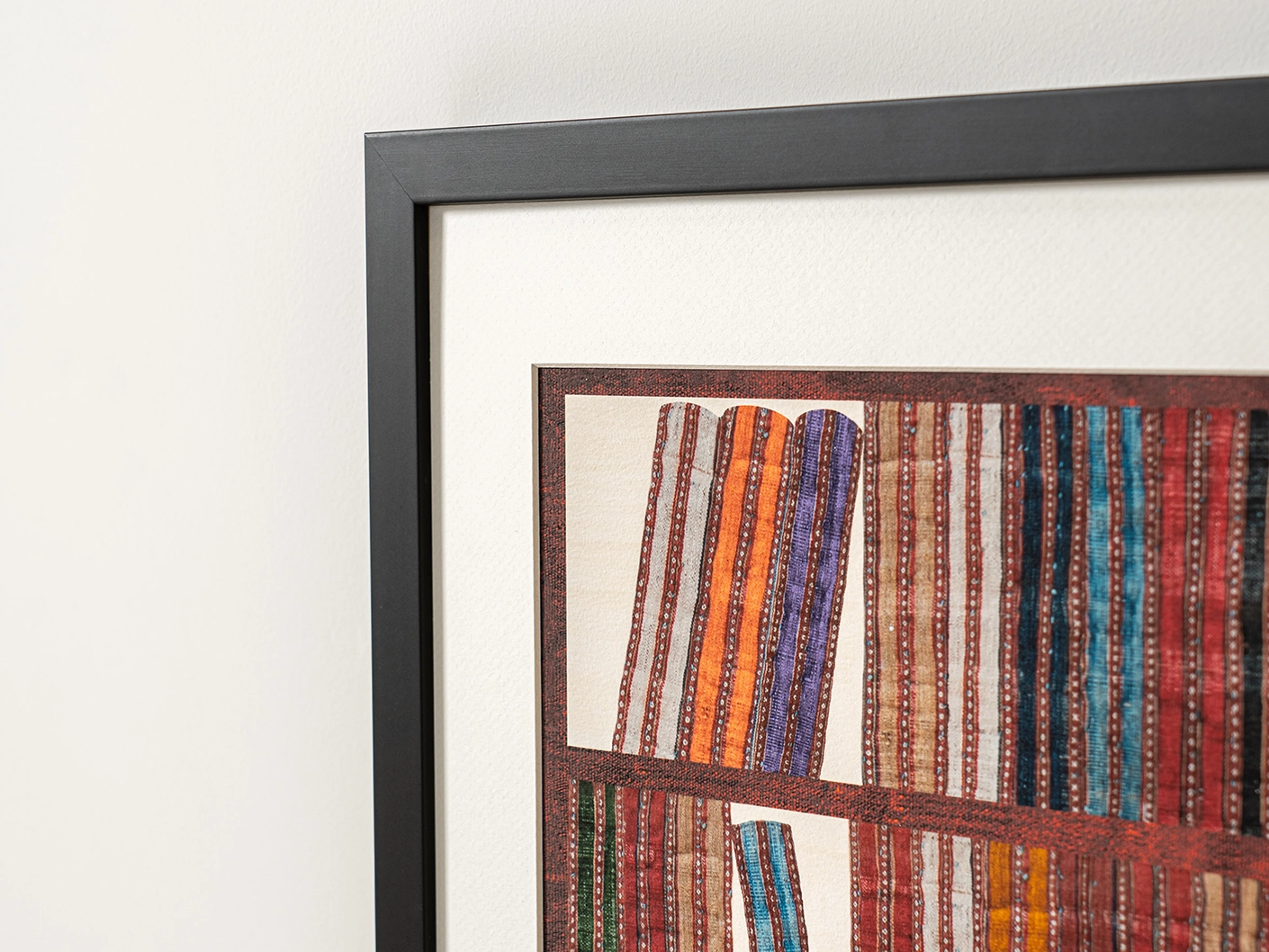Books fine art print in rust, blue and multicolour, shown in a lifestyle close-up view as image 1