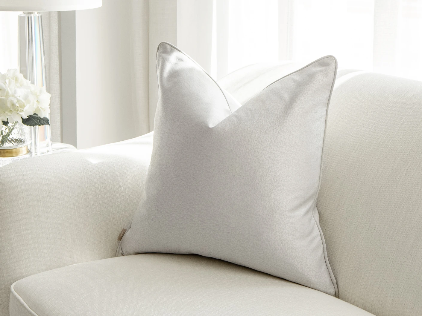 Celeste Hodler single cushions in silver, shown in a lifestyle front view