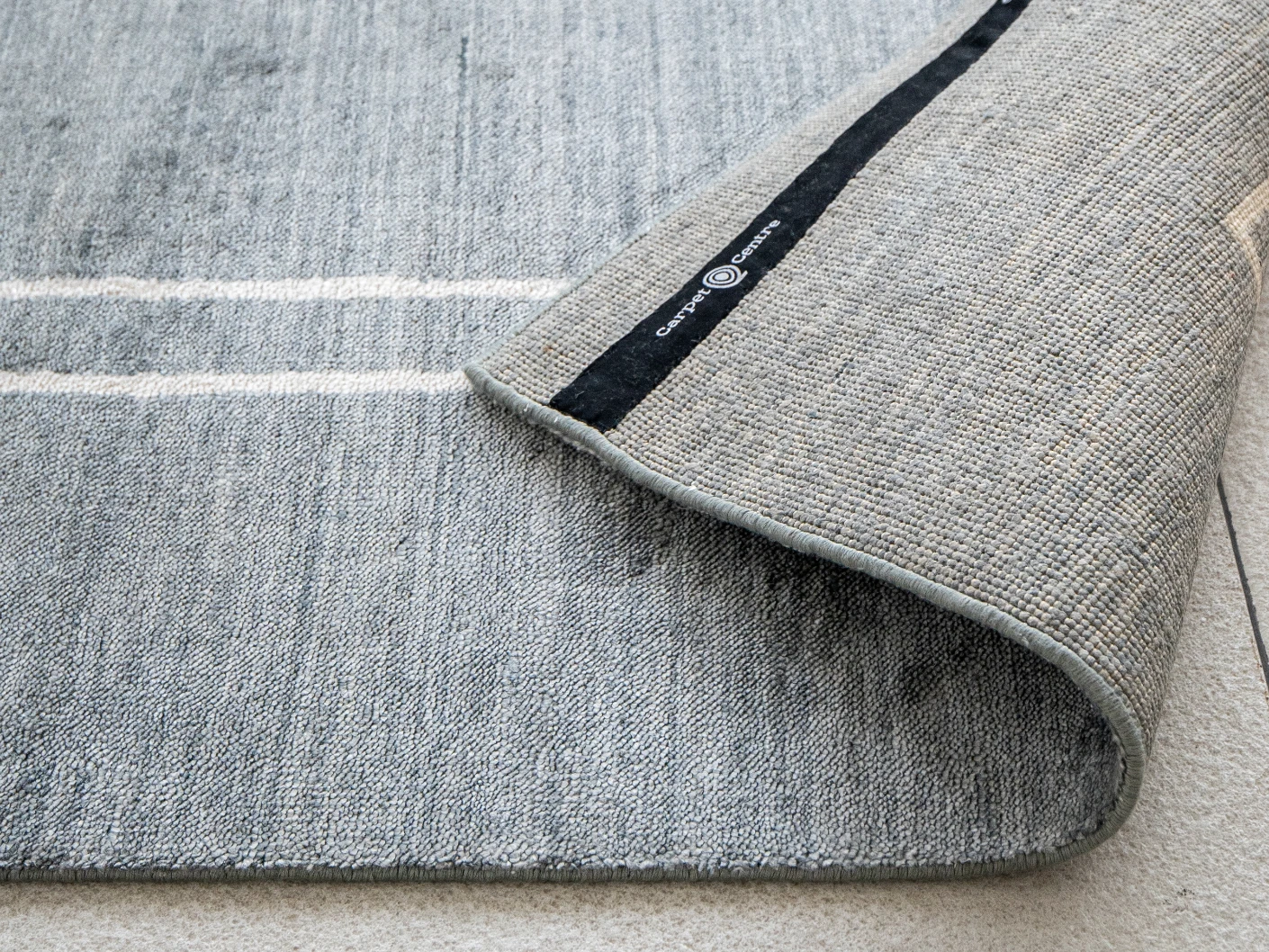 Colin Ashton carpets in blue and white, shown in a product close-up view