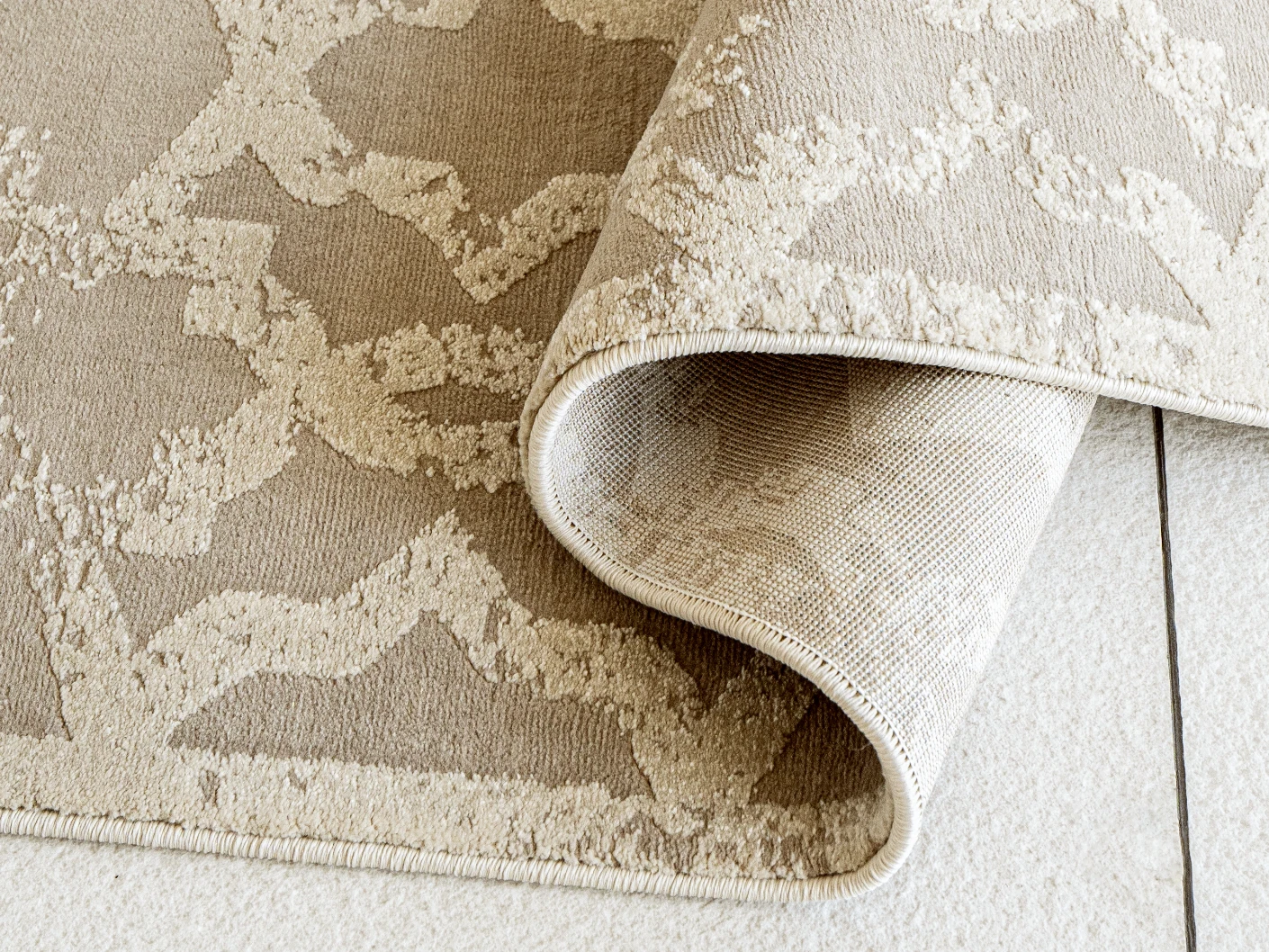 Cooper Sandy carpets in sandy, beige and ivory, shown in a product close-up view