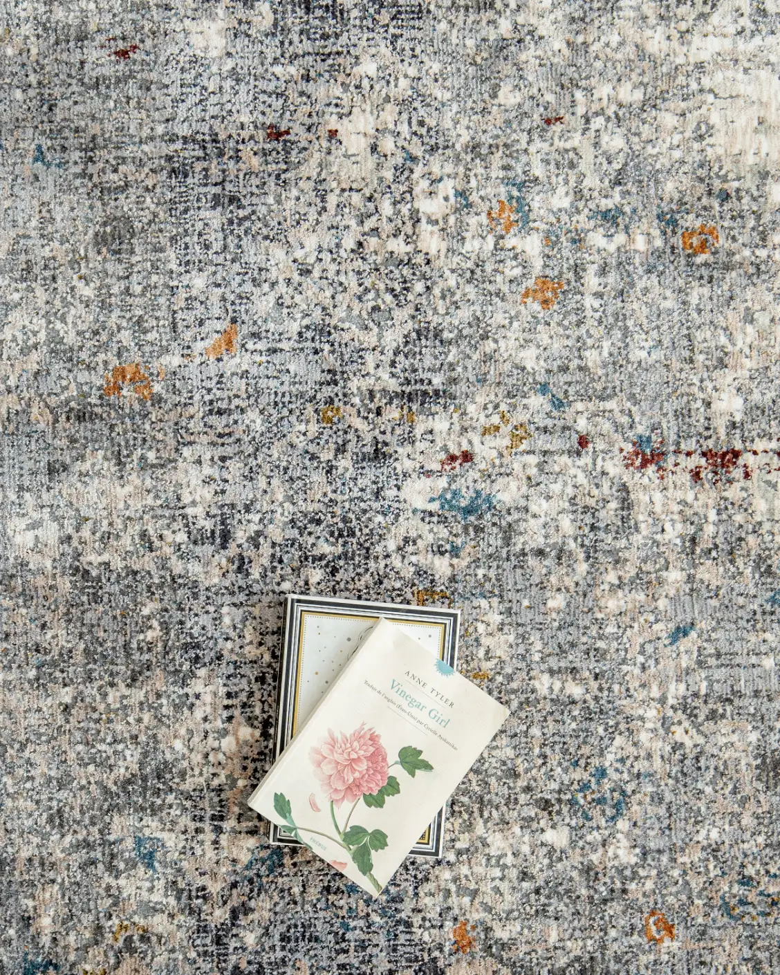 Ethan Ashton carpet in grey and beige, shown in a lifestyle top view as image 8