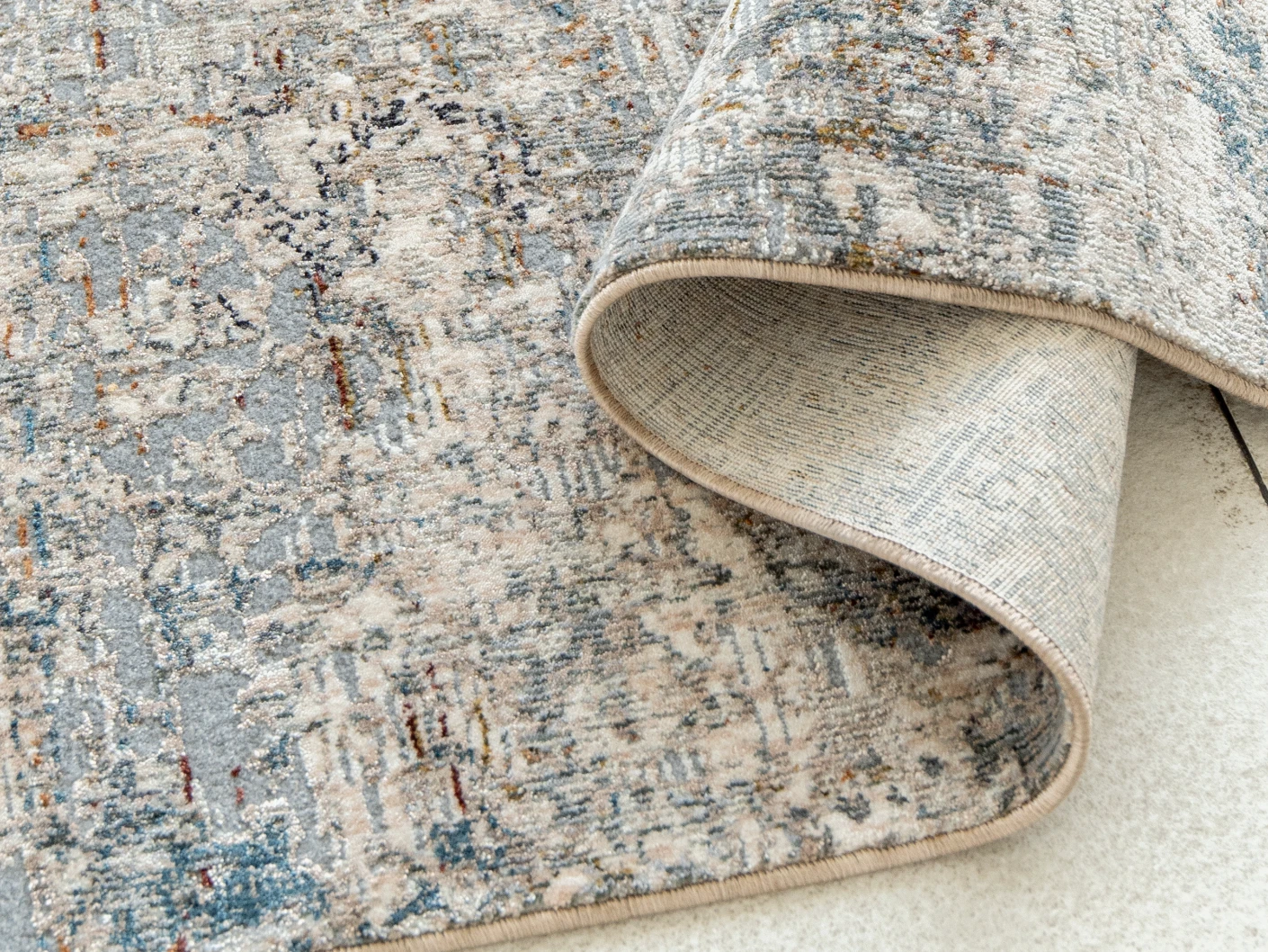 Ethan Brick carpets in gold and grey, shown in a product close-up view