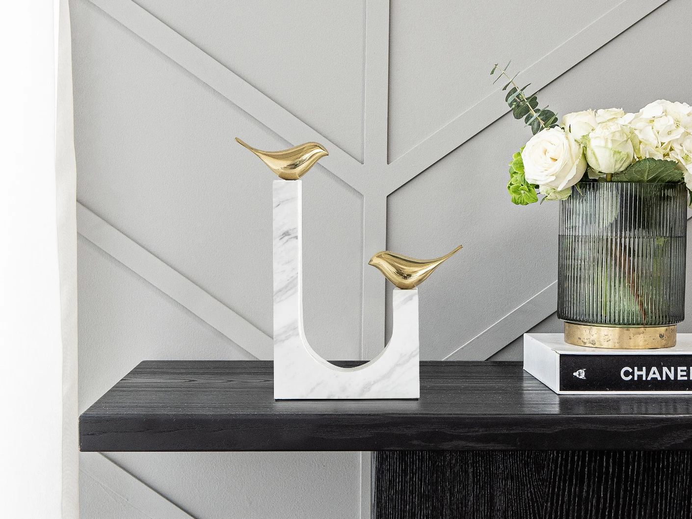 Finch Butterfield statues and sculptures in white and gold, shown in a lifestyle front view