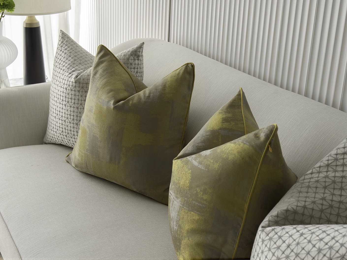Gustave Bundle bundle cushions in silver and gold, shown in a lifestyle front view