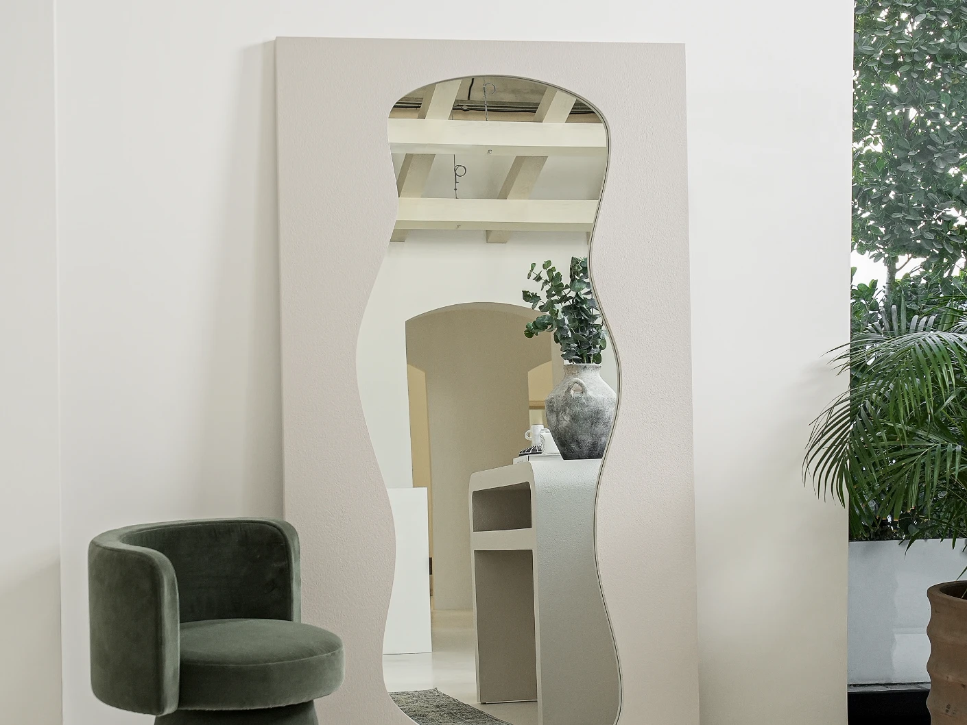 Ivrea mirror in soft ivory and stone, shown in a lifestyle front view