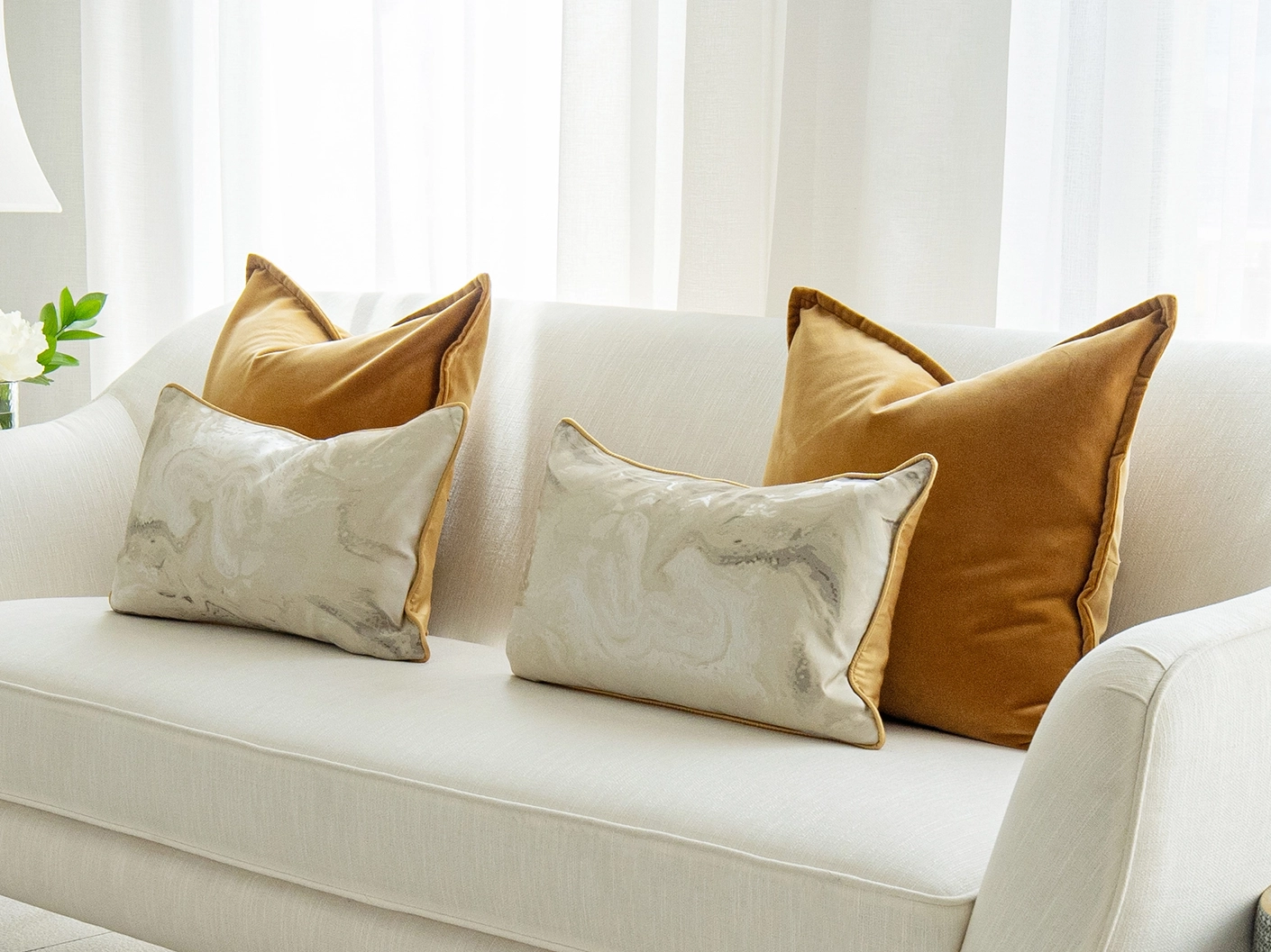 Johan Bundle bundle cushions in orange, silver and yellow, shown in a lifestyle front view