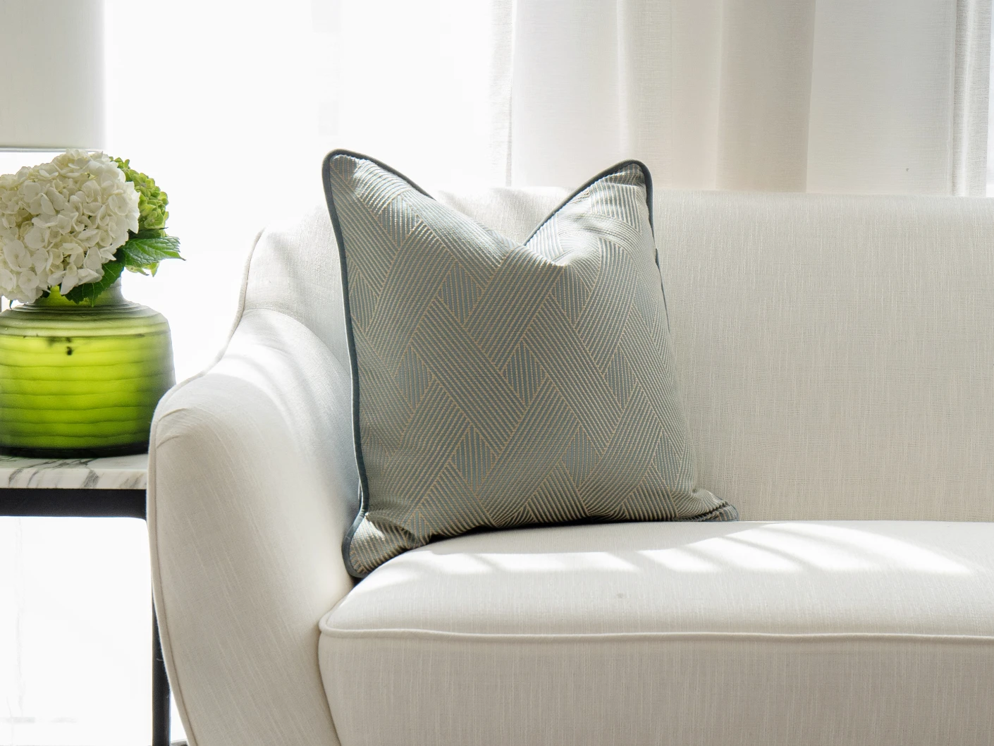 Lucas Matisse single cushions in blue, shown in a lifestyle front view
