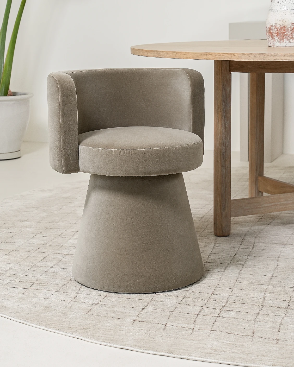 Mara Alpaca swivel chair in brown, shown in a lifestyle left view as image 2