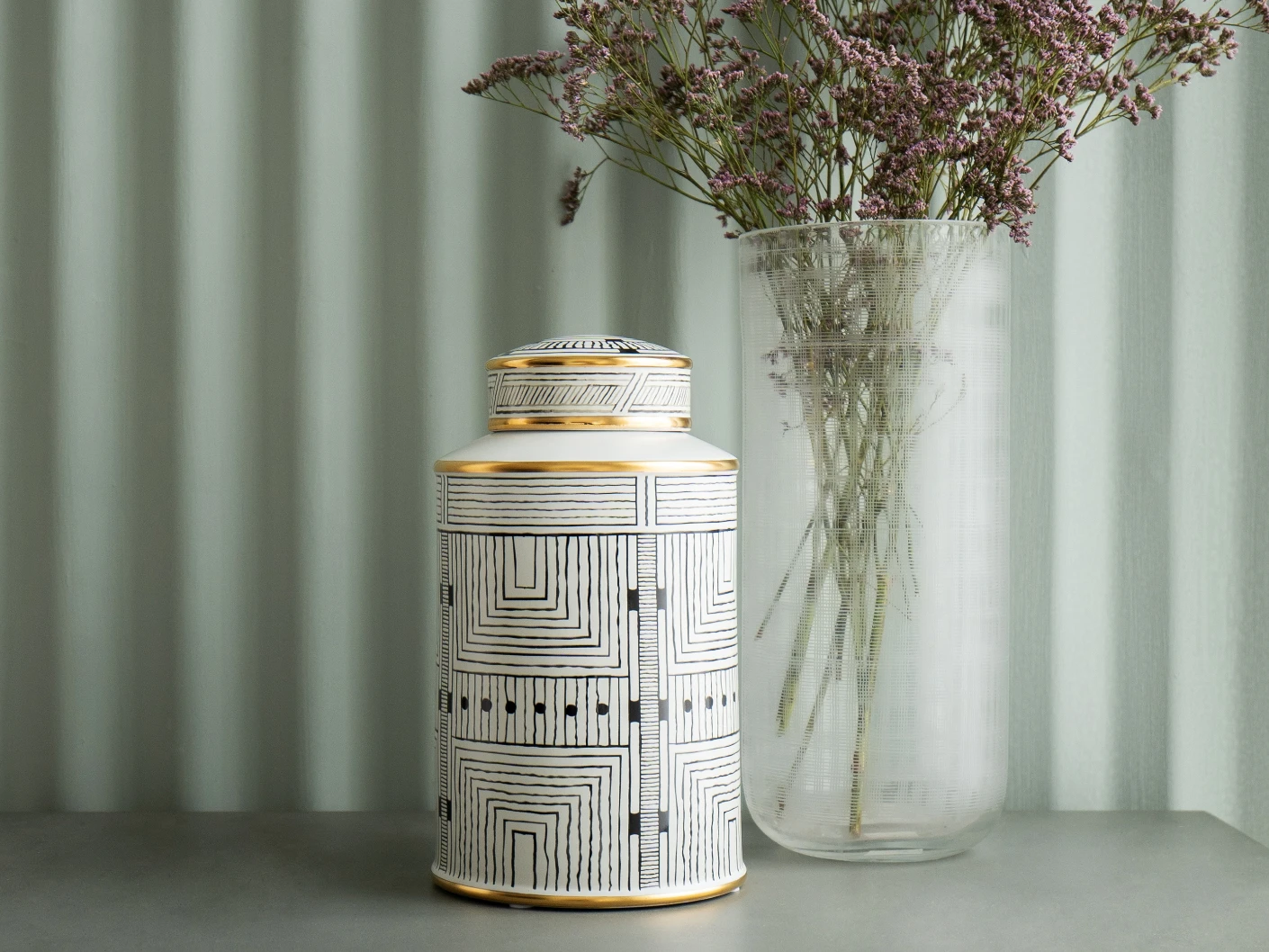 Maze Arneson II canisters in black and white, shown in a lifestyle front view