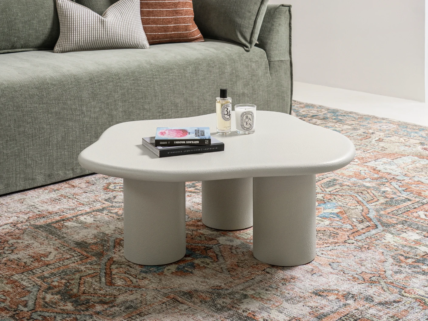 Pienza coffee table in soft ivory and stone, shown in a lifestyle left view