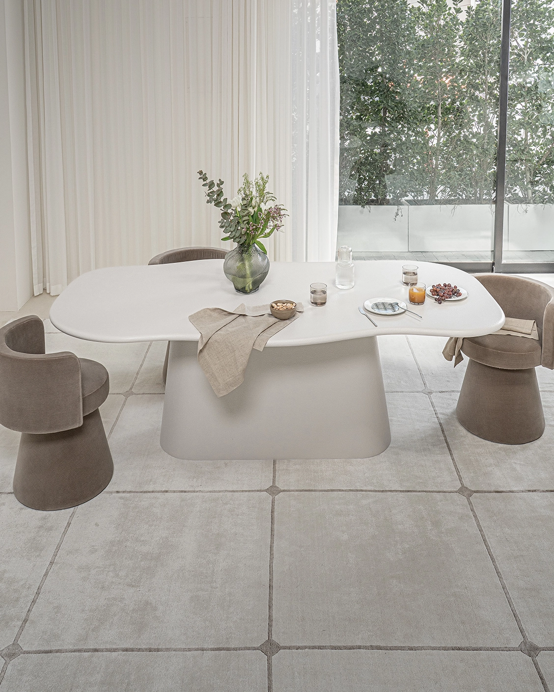Ravenna dining table in soft ivory, stone and ivory, shown in a lifestyle front view as image 2