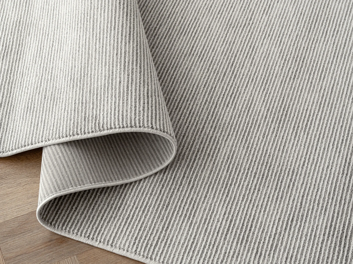 Rik Dune carpets in dune and grey, shown in a product close-up view