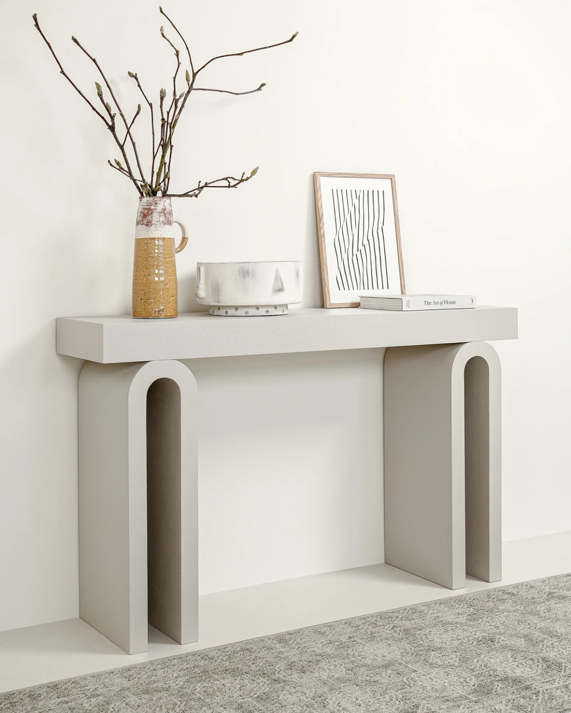 Trento console table in soft ivory and stone, shown in a lifestyle left view as image 2