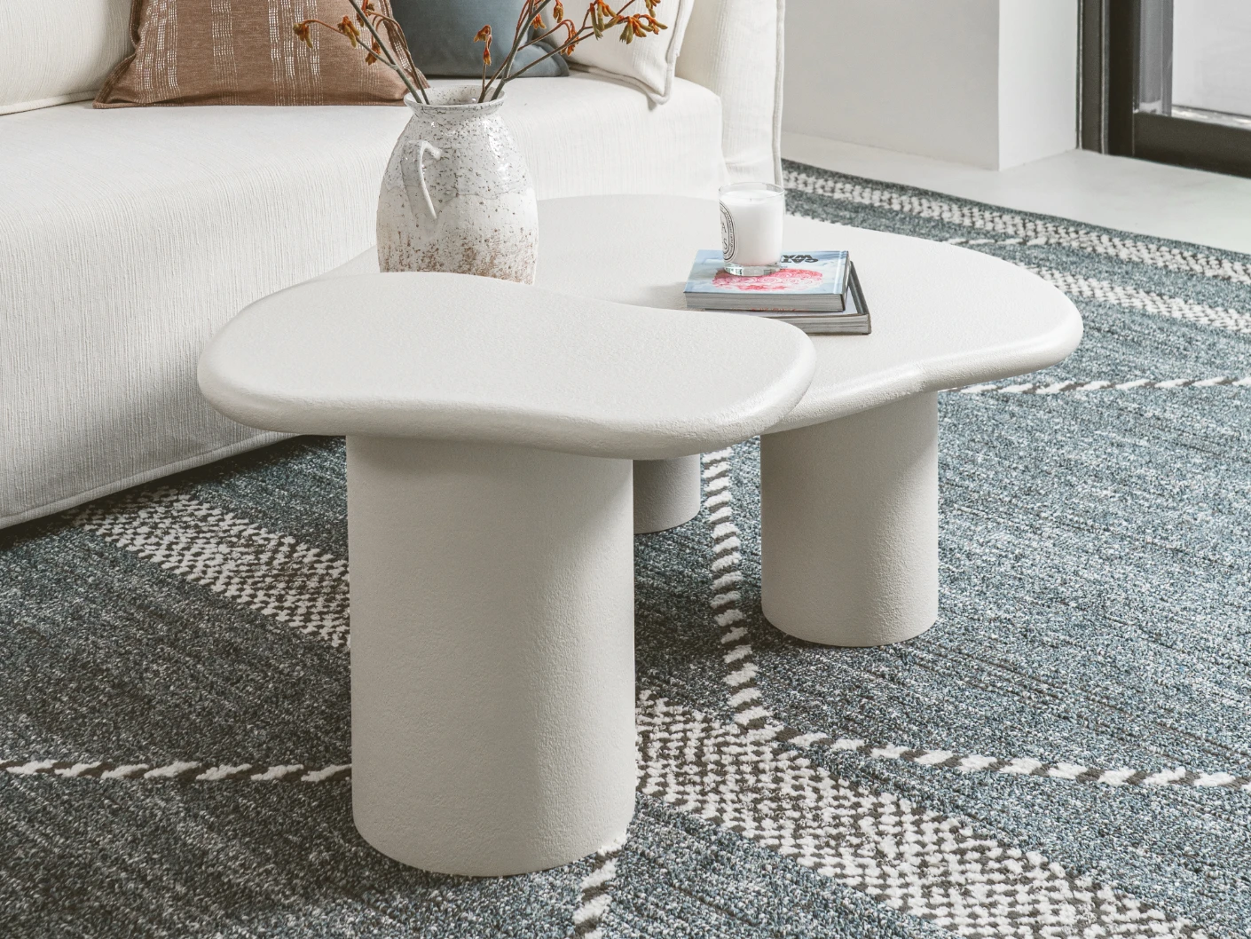 Verona side table in soft ivory and stone, shown in a lifestyle left view as image 2