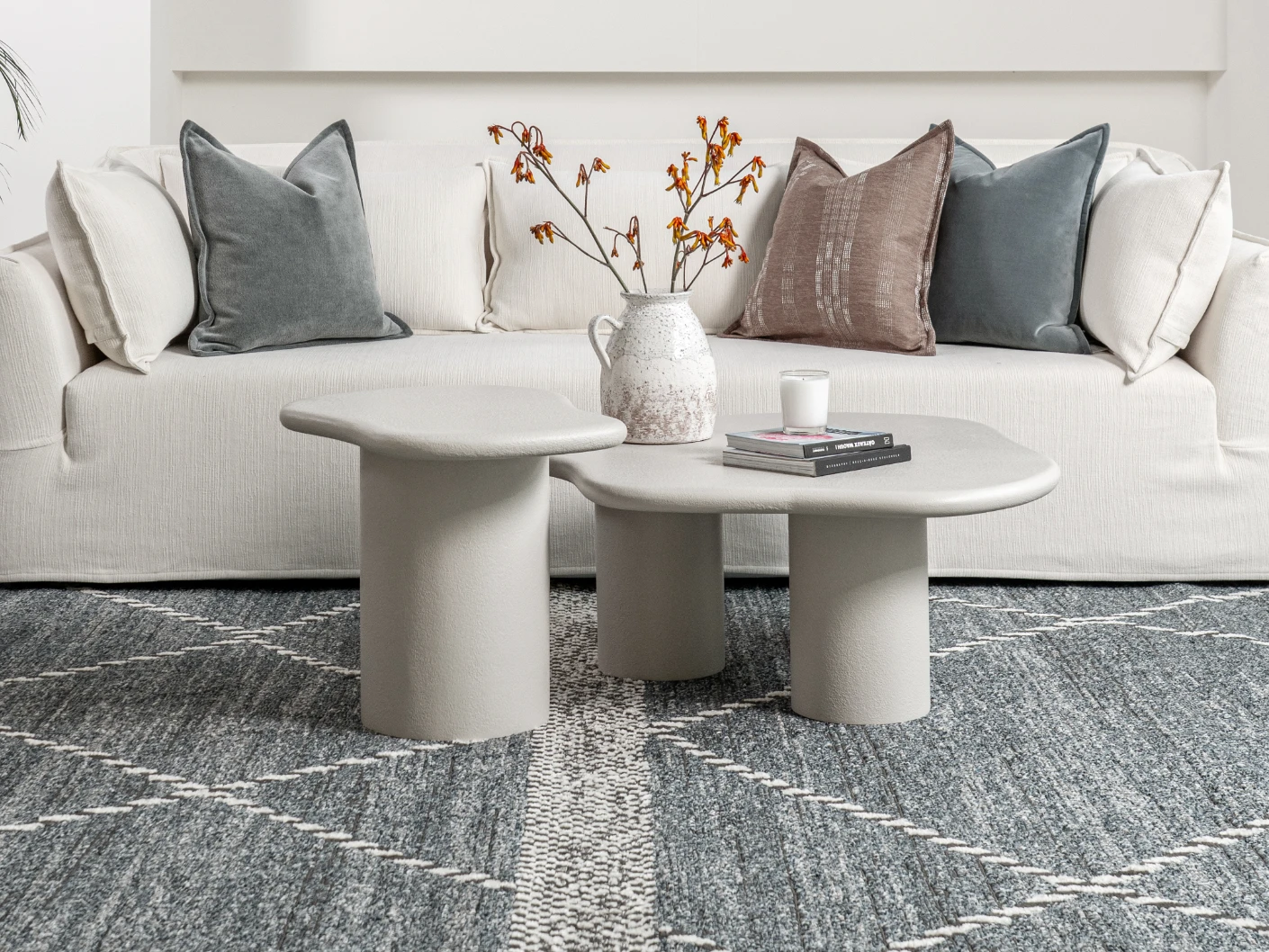 Verona side table in soft ivory and stone, shown in a lifestyle front view
