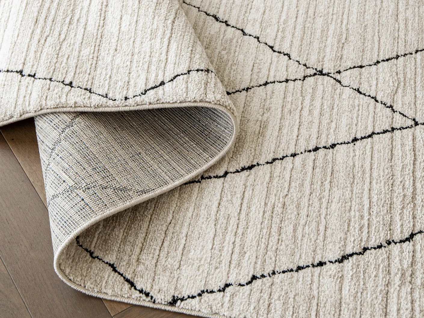 Zen Pearl carpets in pearl, charcoal and ivory, shown in a product close-up view