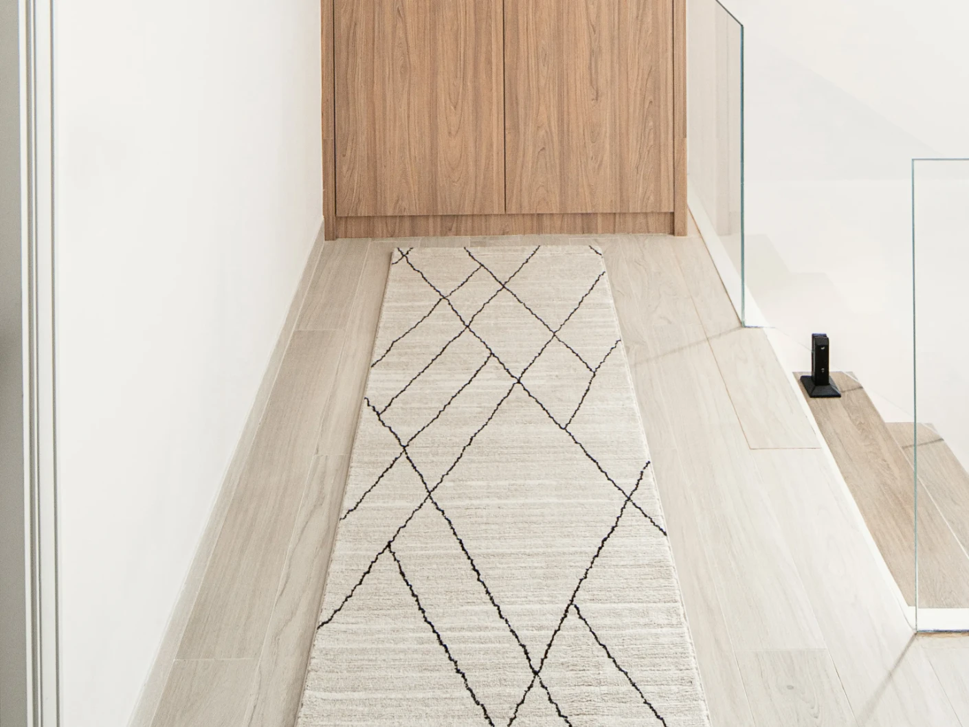 Zen Pearl Runners carpet in charcoal and ivory, shown in a lifestyle front view