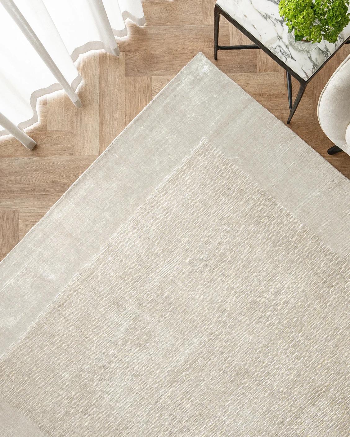 Luna Clay carpet in beige, shown in a lifestyle top view as image 2