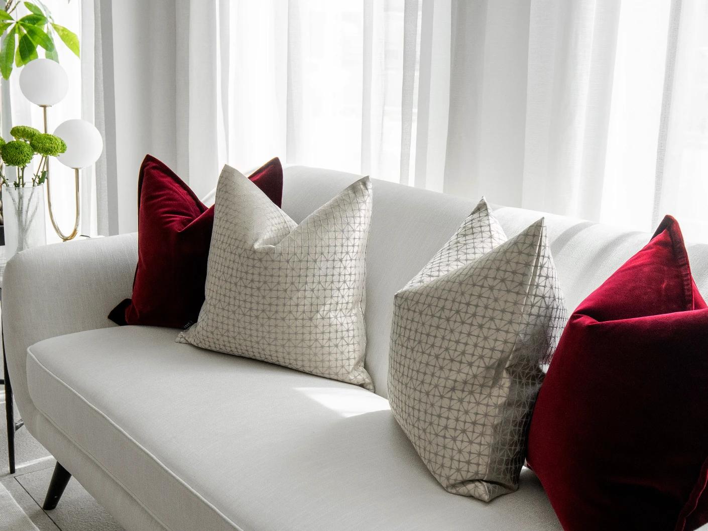 Cerise Bundle cushion in red, silver and white, shown in a lifestyle right view as image 5
