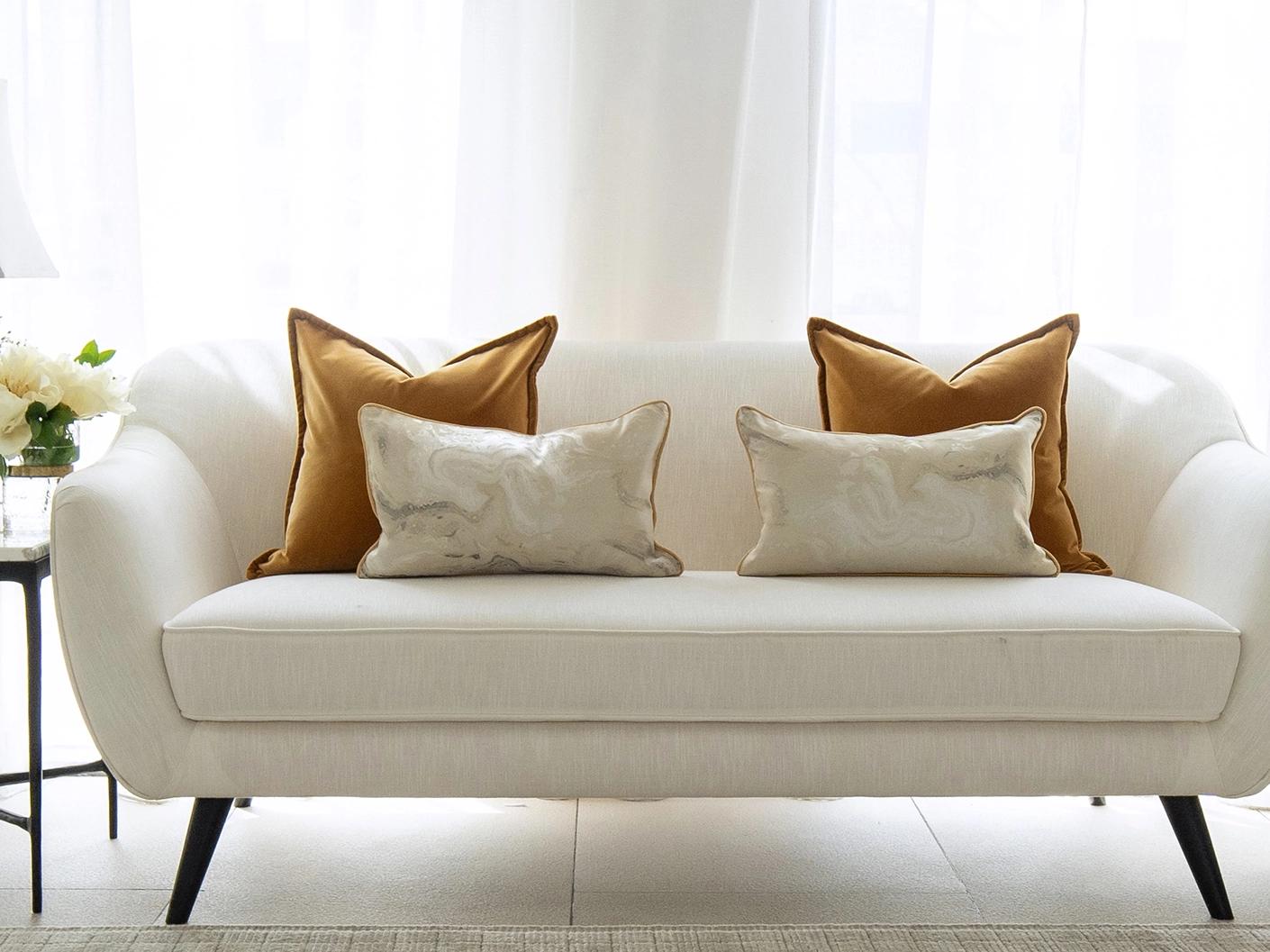 Johan Bundle cushion in orange, silver and yellow, shown in a lifestyle front view as image 4