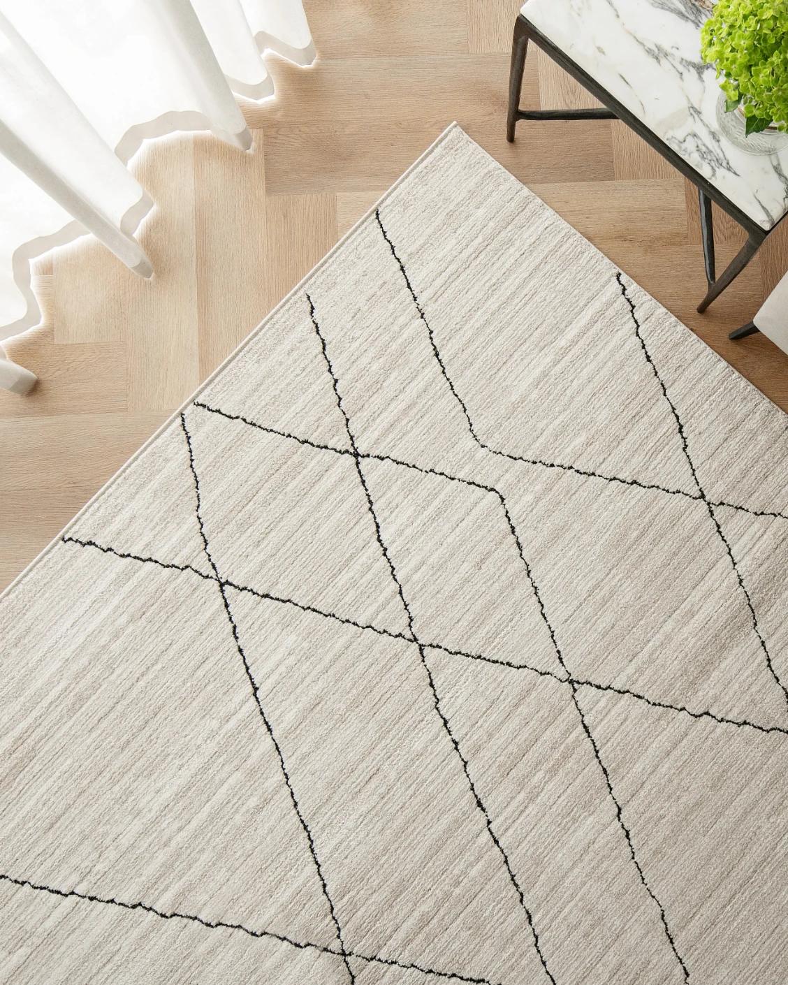 Zen Pearl carpet in charcoal and ivory, shown in a lifestyle top view as image 2